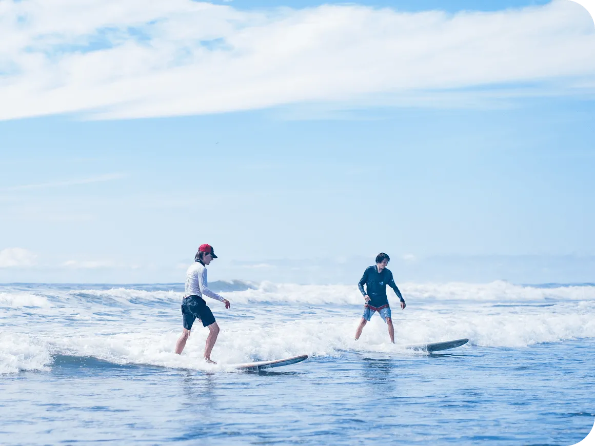 Surfers practising on long boards in gentle coastal waves